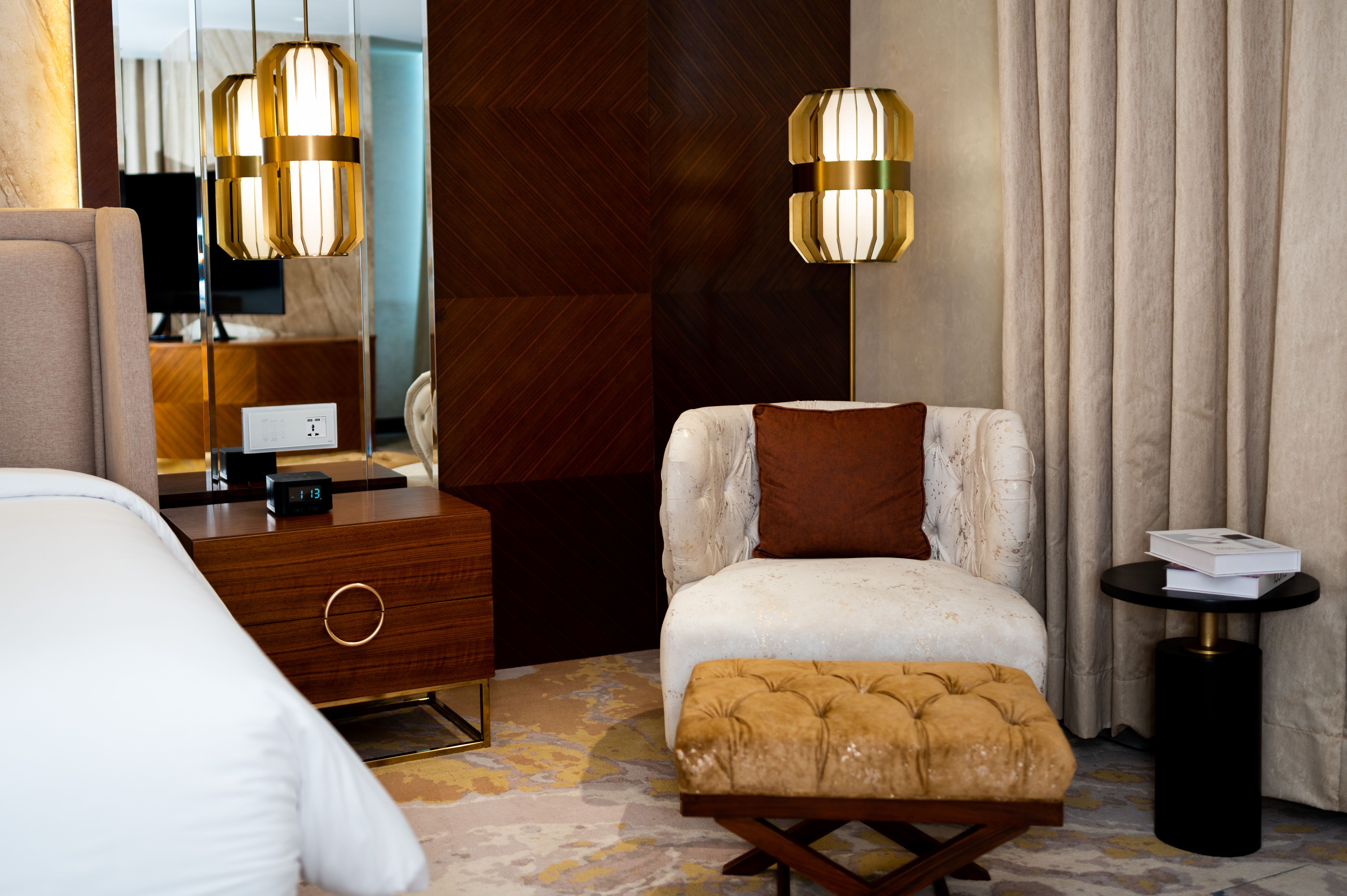 Luxurious hotel room with plush seating and stylish lighting