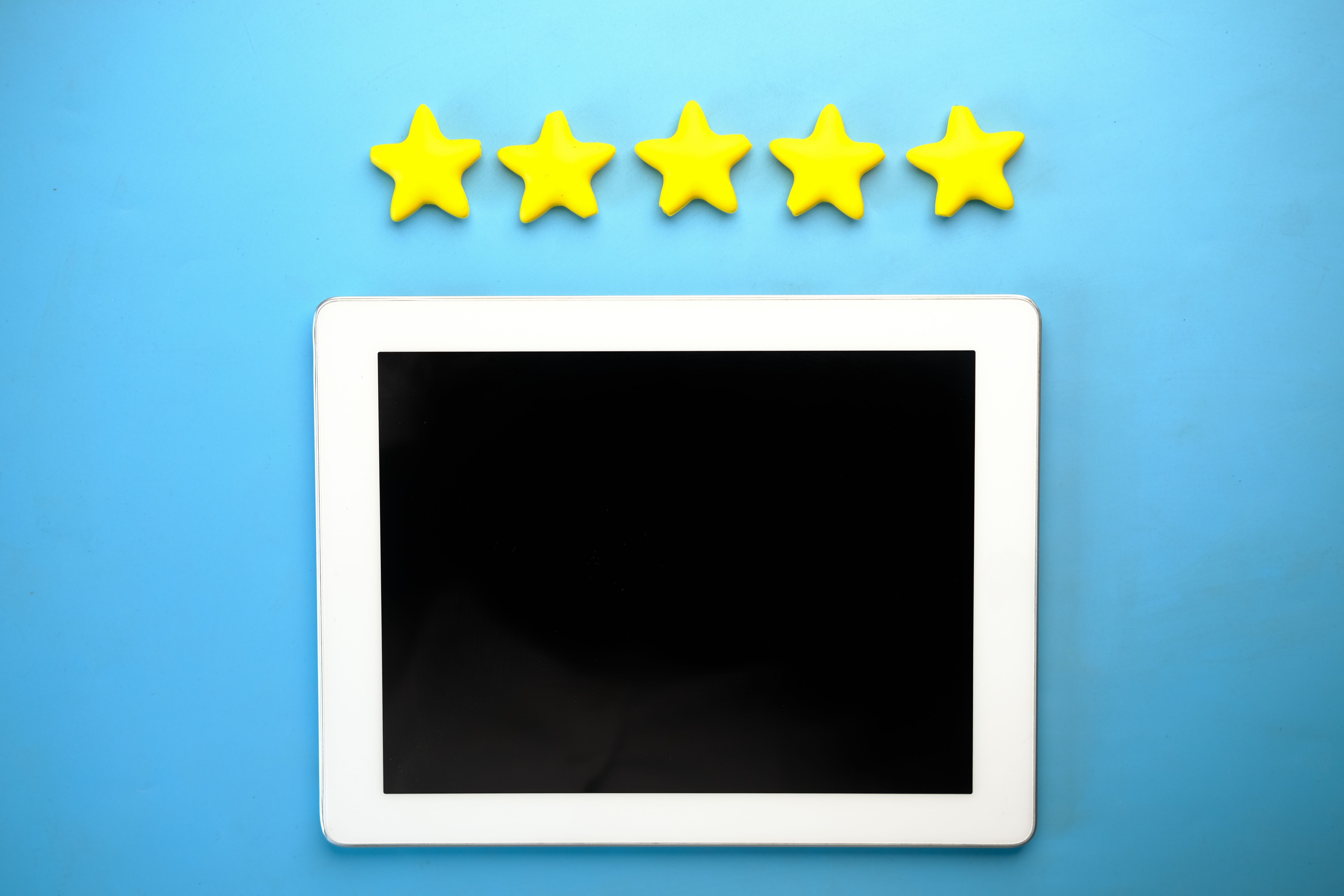 Tablet screen showing five yellow star rating for a review