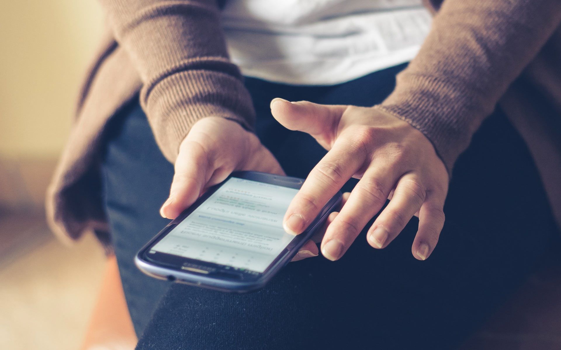 Close-up of a person browsing hotel reviews on a smartphone