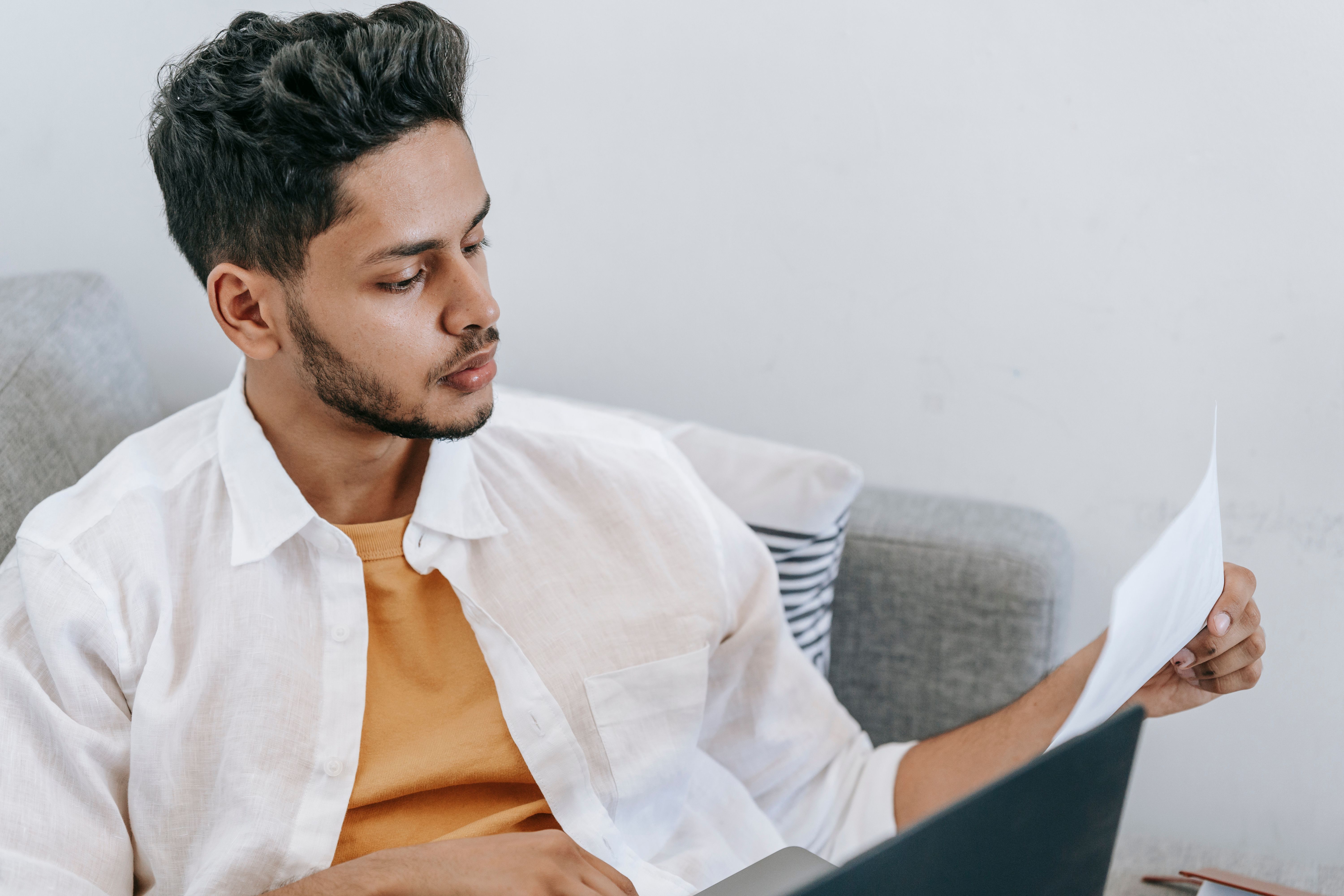 Traveler carefully reading reviews on a laptop before booking a trip